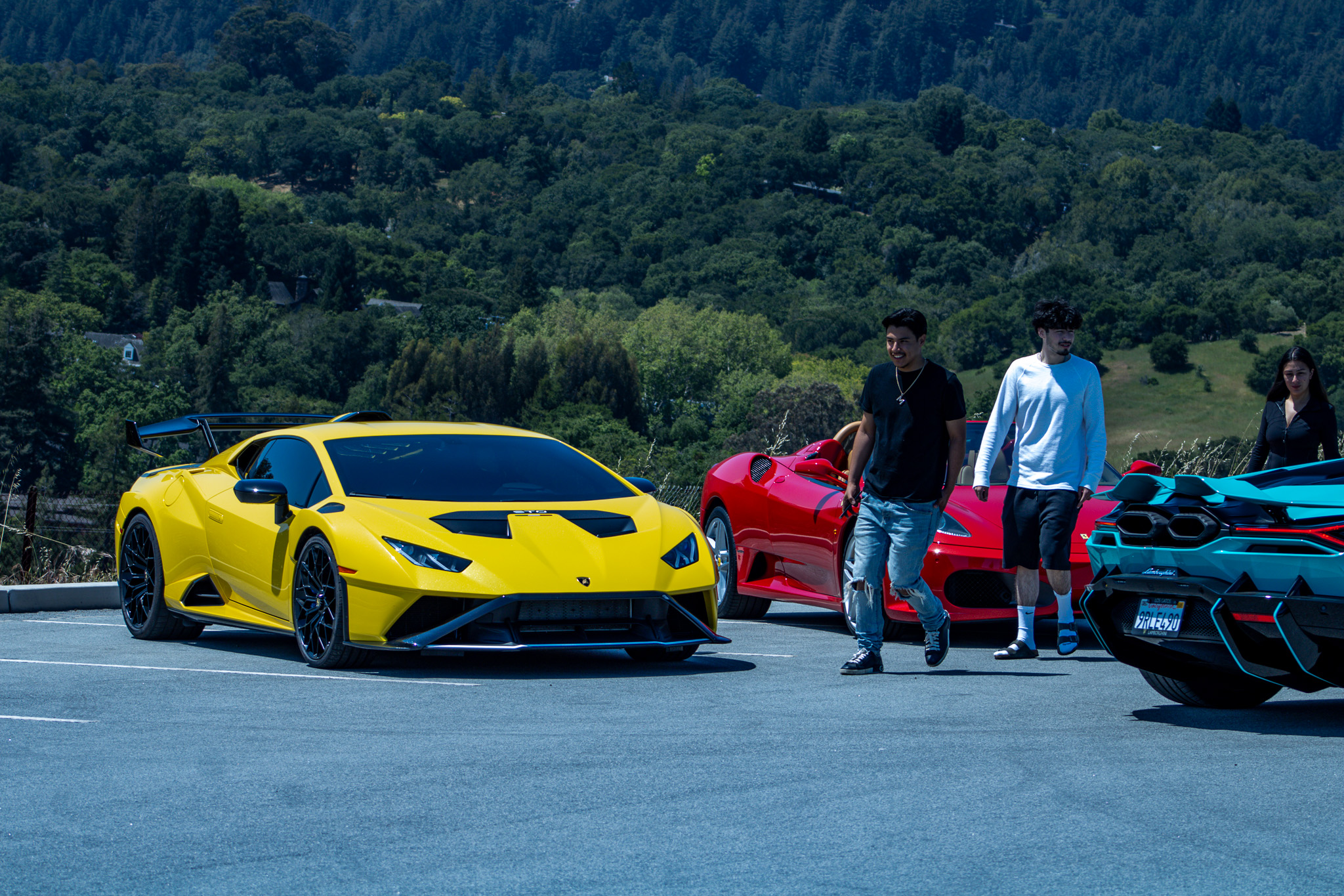 2021 Lamborghini Huracán STO in Yellow, 2006 Ferrari F430 in Red & 2024 Lamborghini Revuelto in Light Blue
